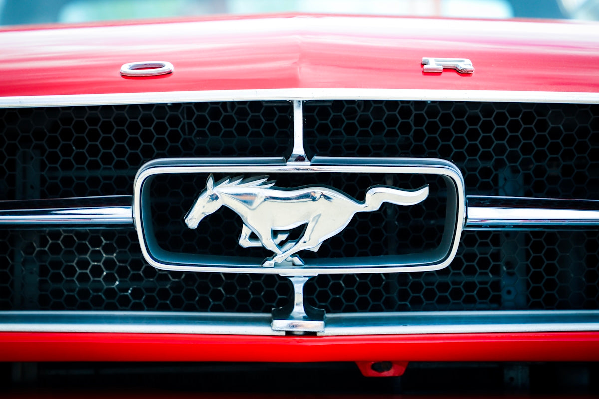 closeup photo of red and chrome Ford Mustang grille