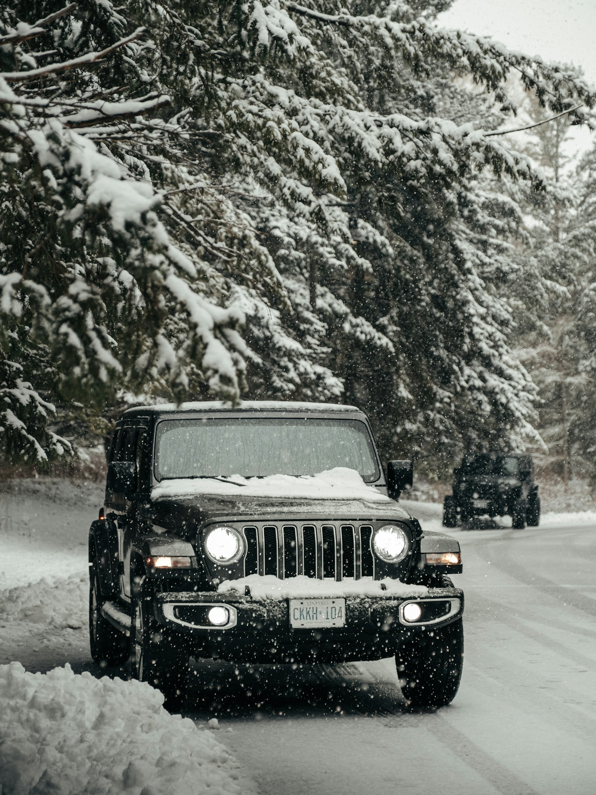 black jeep wrangler on snow covered road during daytime