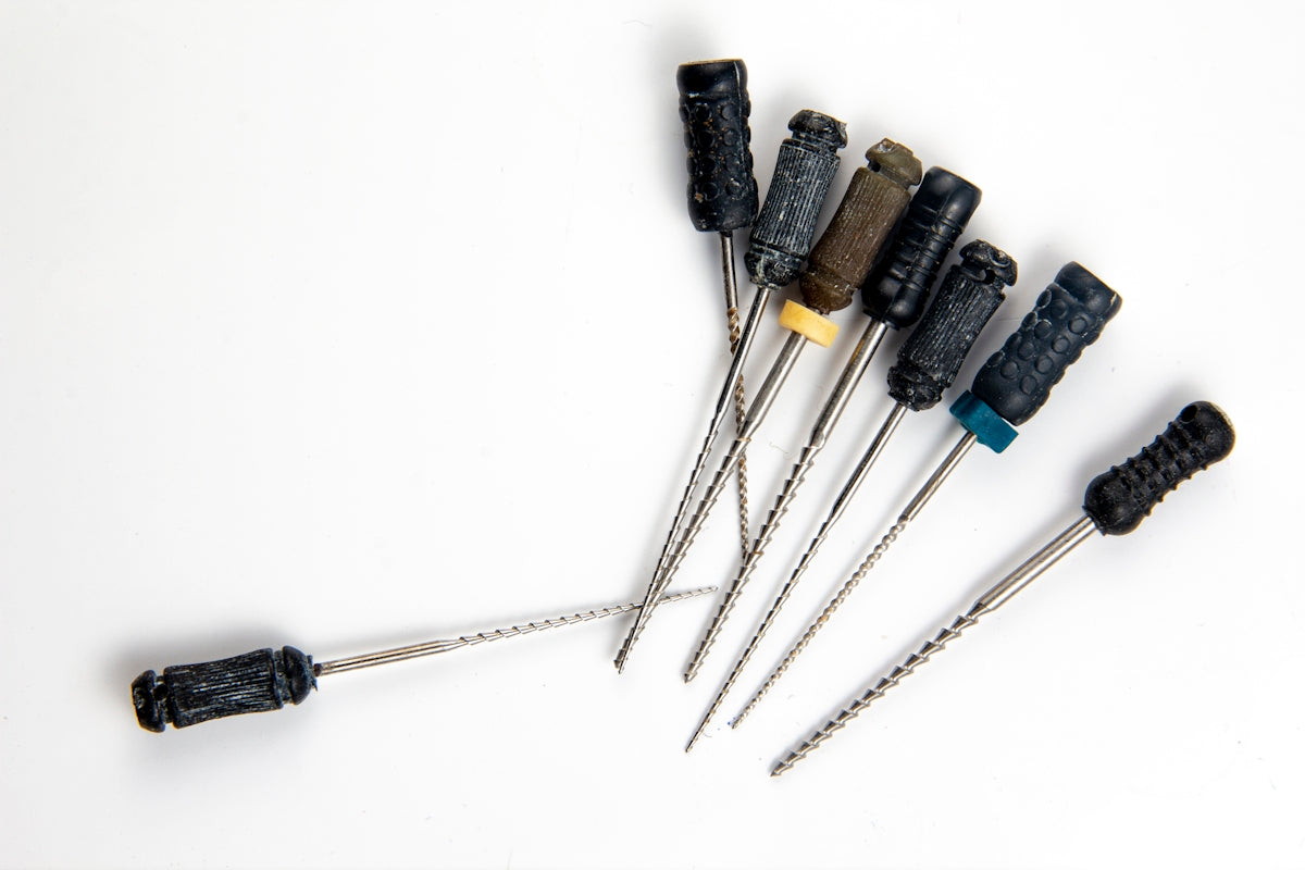 a bunch of screws are lined up on a white surface