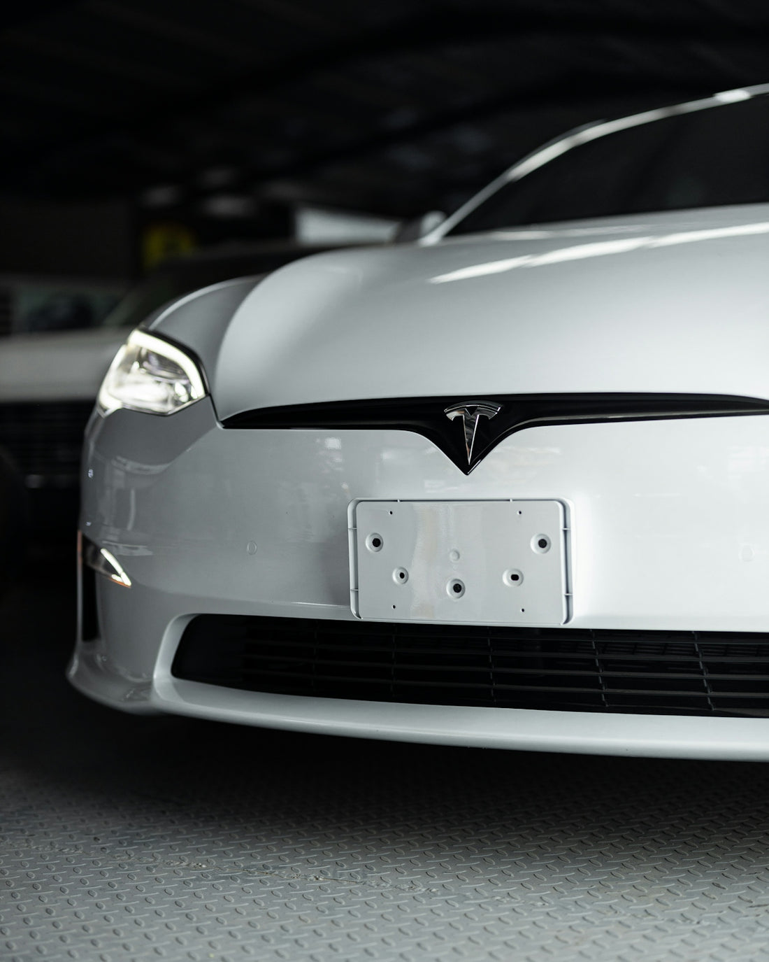 a white car is parked in a garage