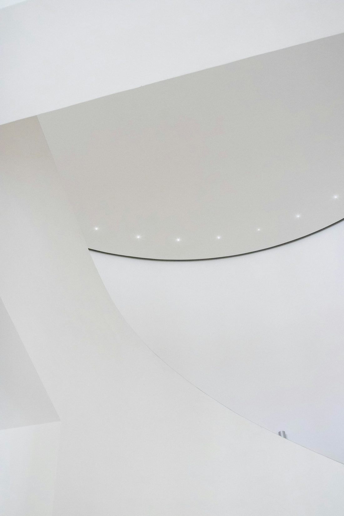 a man riding a skateboard on top of a white wall