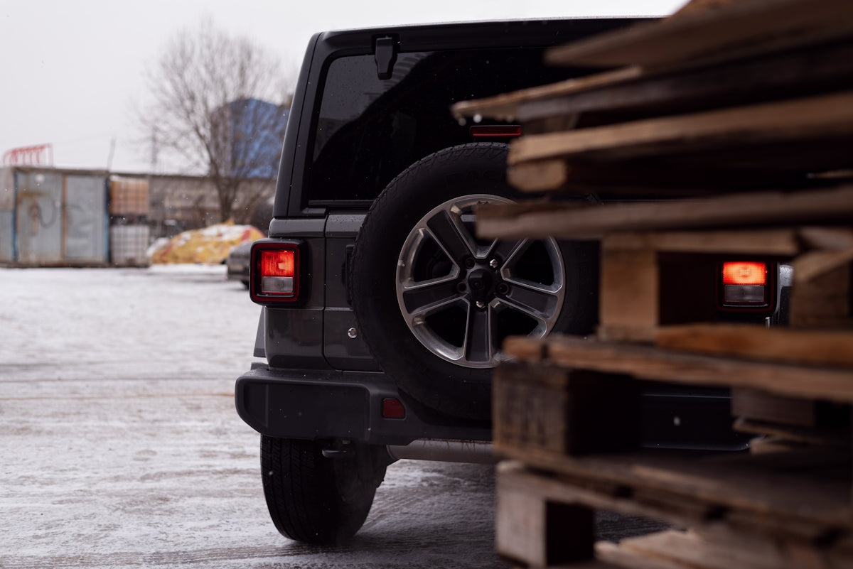 a black jeep parked in a parking lot