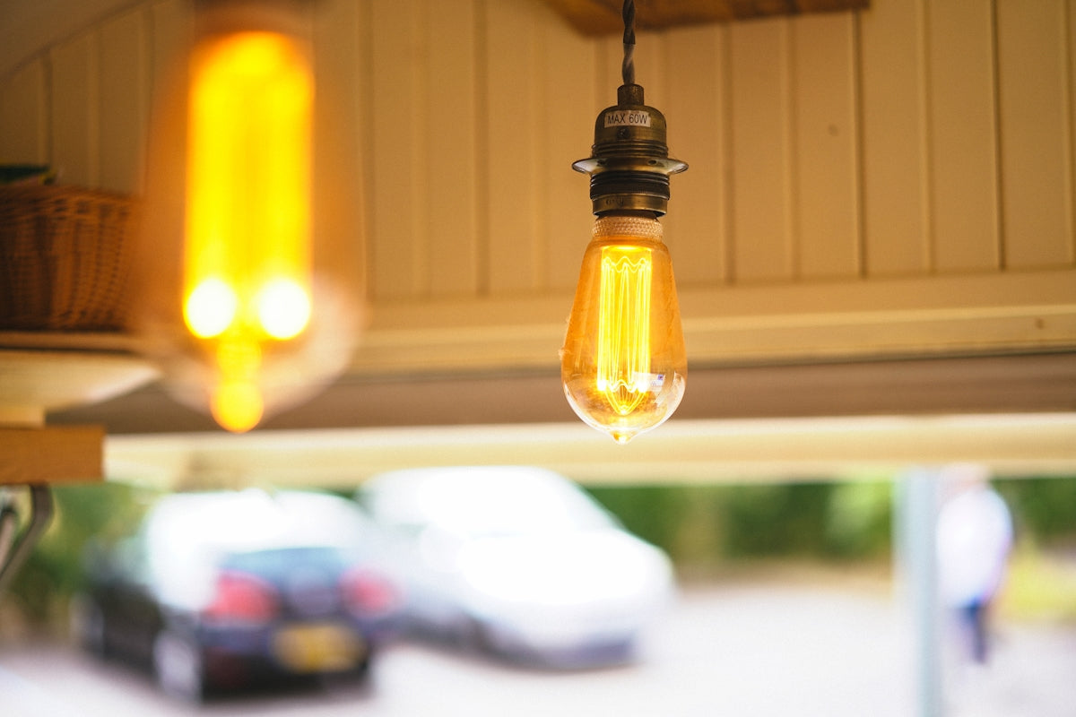 A couple of light bulbs hanging from a ceiling