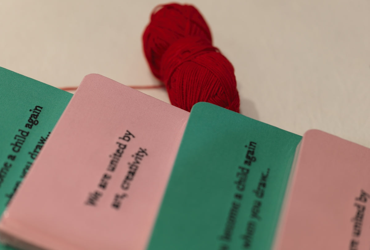 A red ball of yarn sitting on top of a table