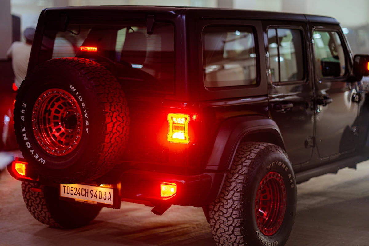 A black jeep parked in a parking garage