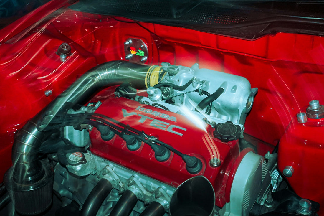 A close up of a red car engine