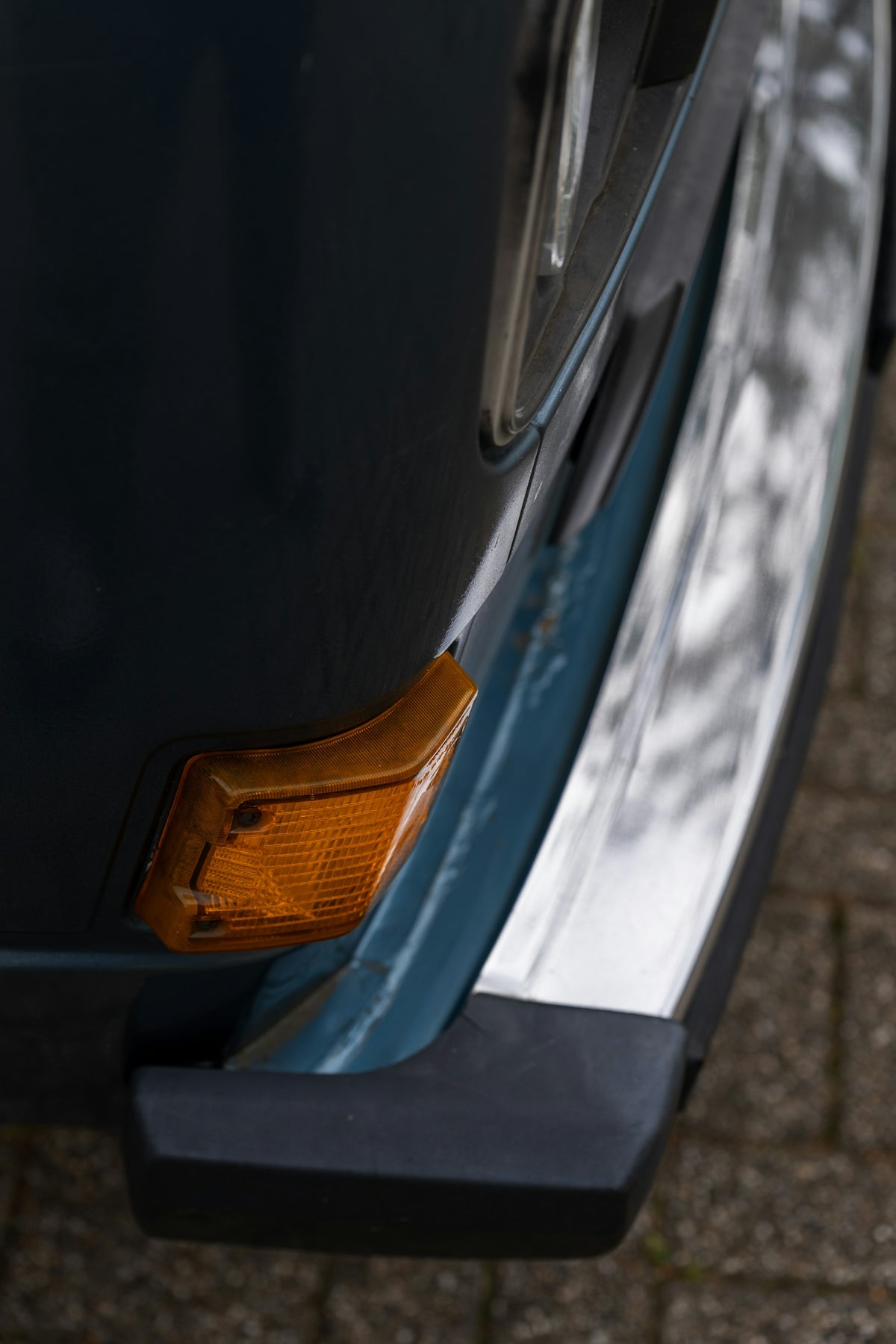 Close-up of a vintage car's turn signal and bumper