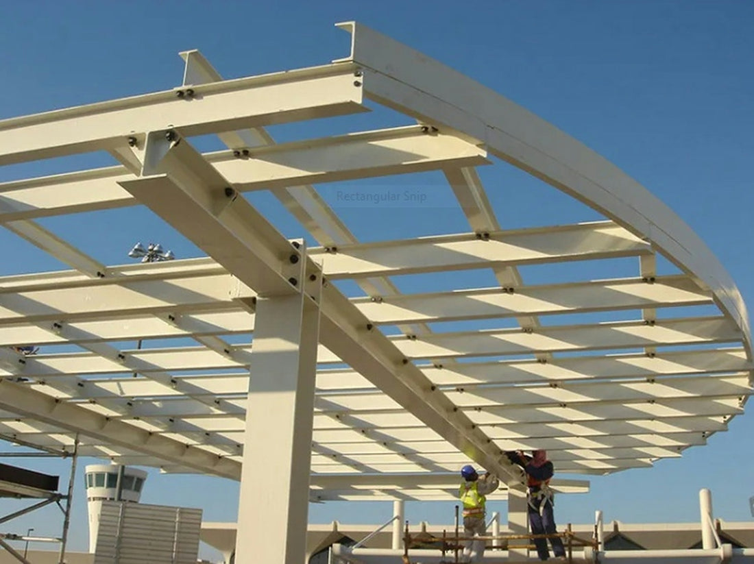Two construction workers build a large white steel canopy structure