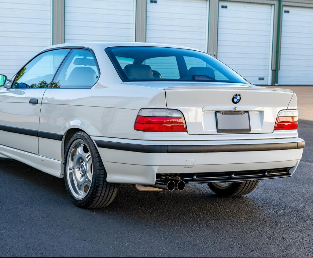 Euro style red/clear tail lights installed on a white BMW E36 coupe