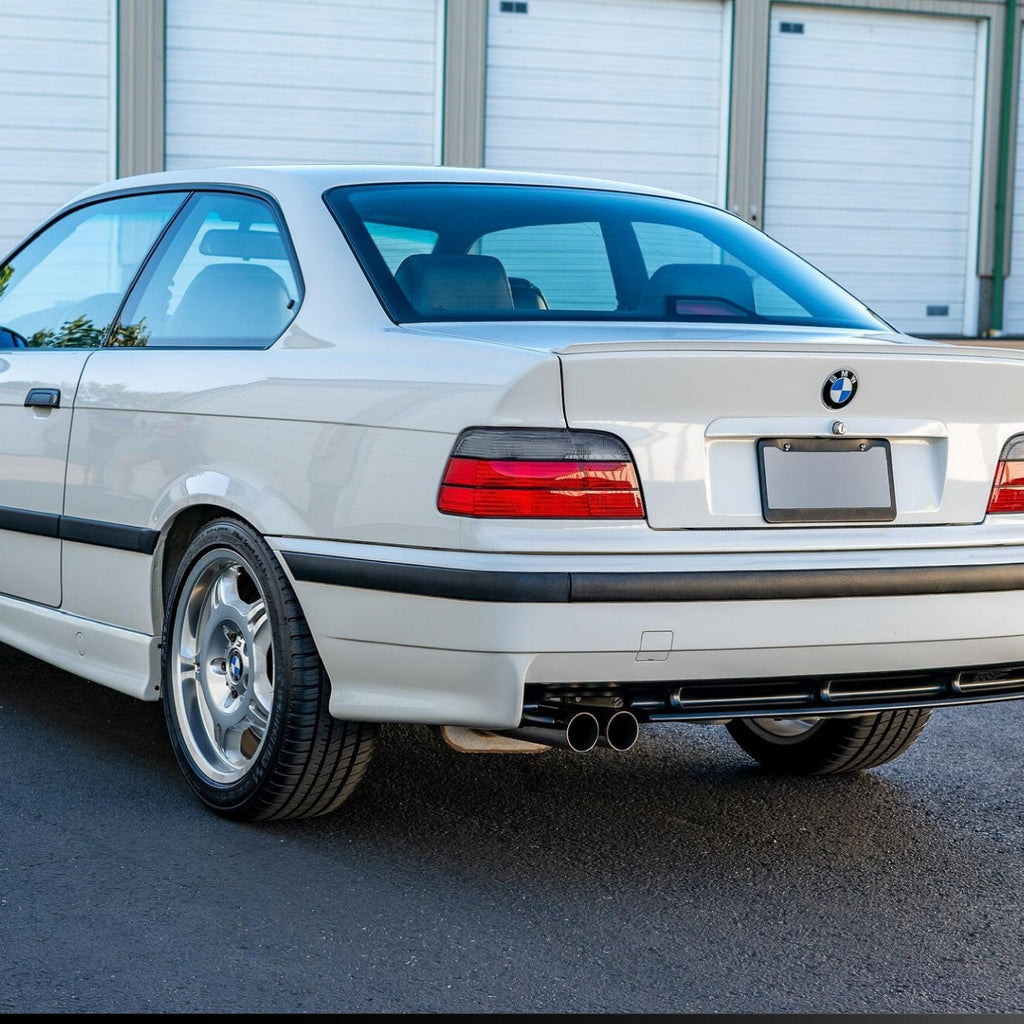 Euro red/smoke tail lights installed on a white BMW E36 coupe