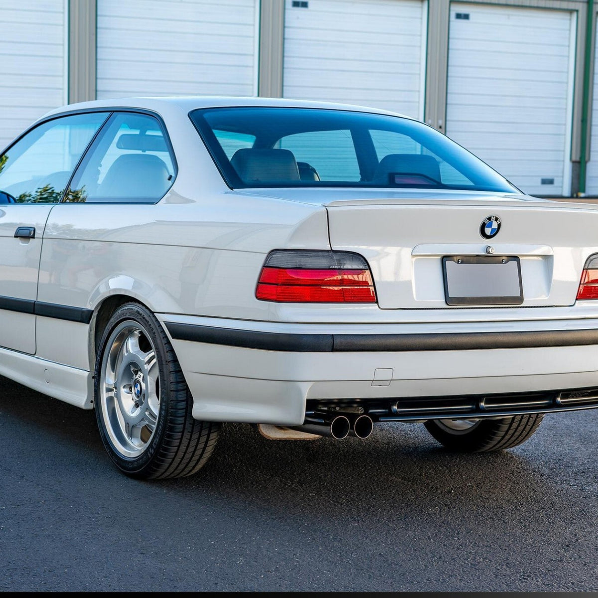 Euro red/smoke tail lights installed on a white BMW E36 coupe