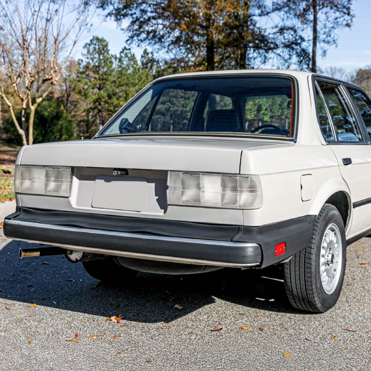 All clear tail lights installed on a white BMW E30 sedan