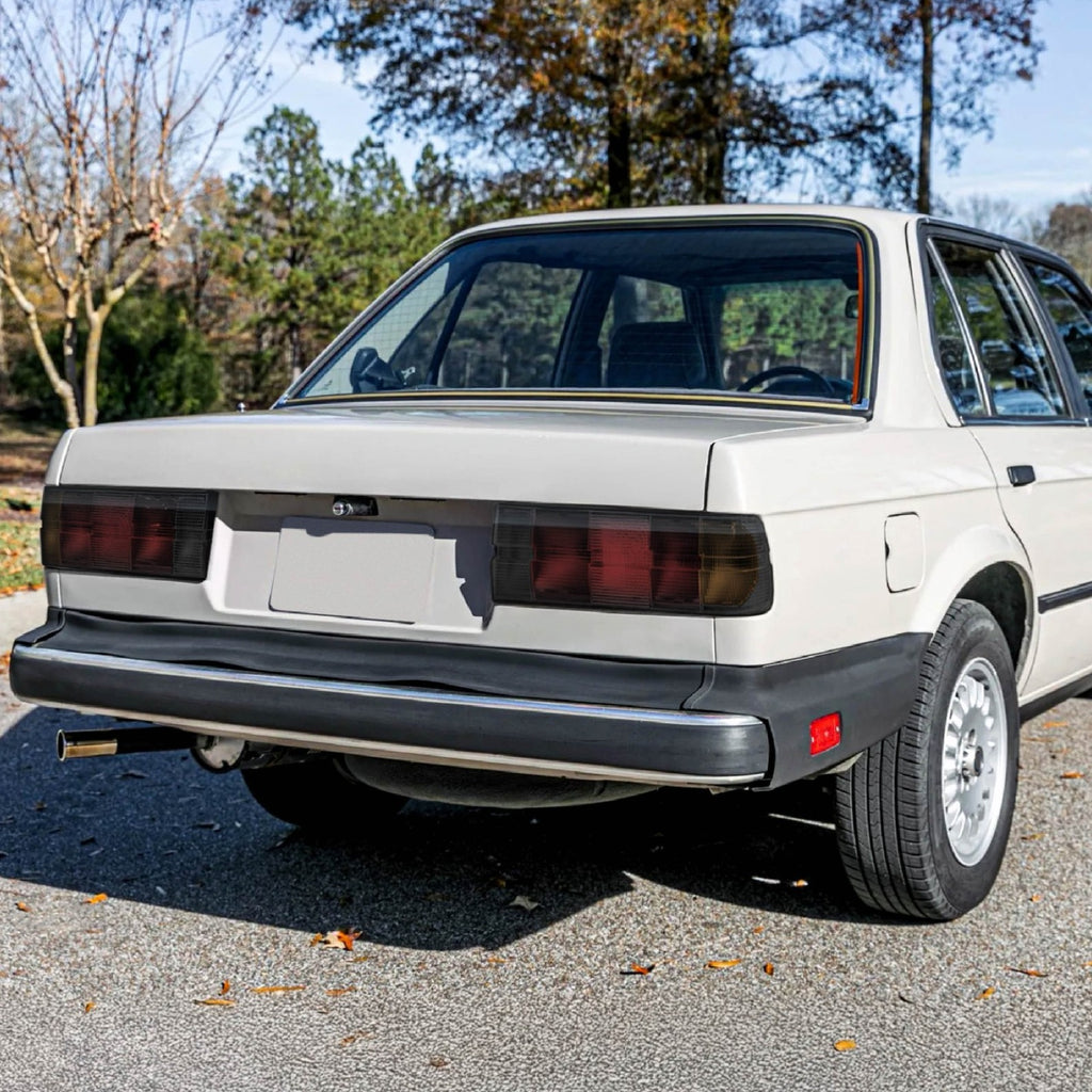 Euro smoke tail lights installed on a white BMW E30 sedan