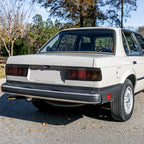 Euro smoke tail lights installed on a white BMW E30 sedan