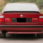 Euro style red/clear tail lights installed on a red BMW E34 5 Series sedan