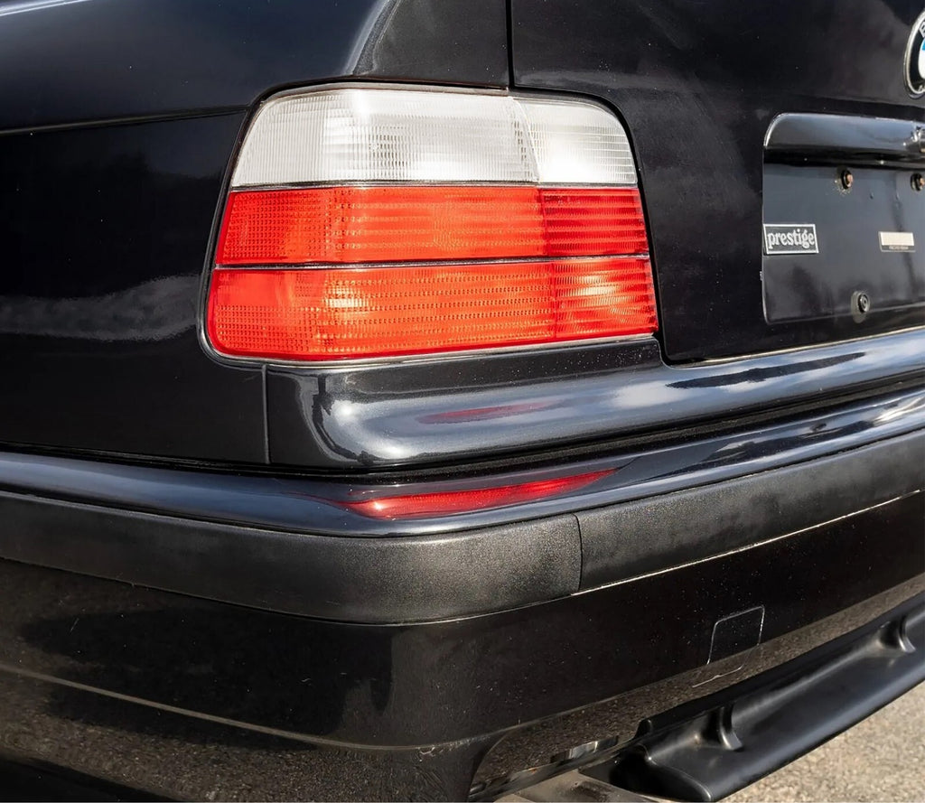 Euro style red/clear tail light installed on a black BMW E36 sedan