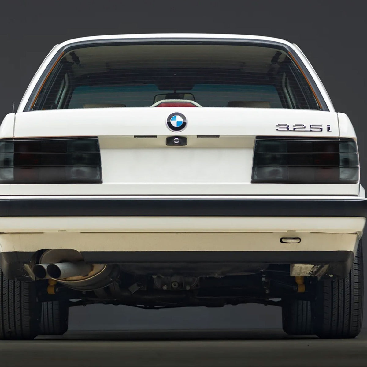 Euro smoke tail lights installed on a white BMW E30 325i