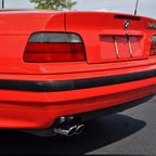 Close-up of red/smoke tail lights on a red BMW E36 convertible