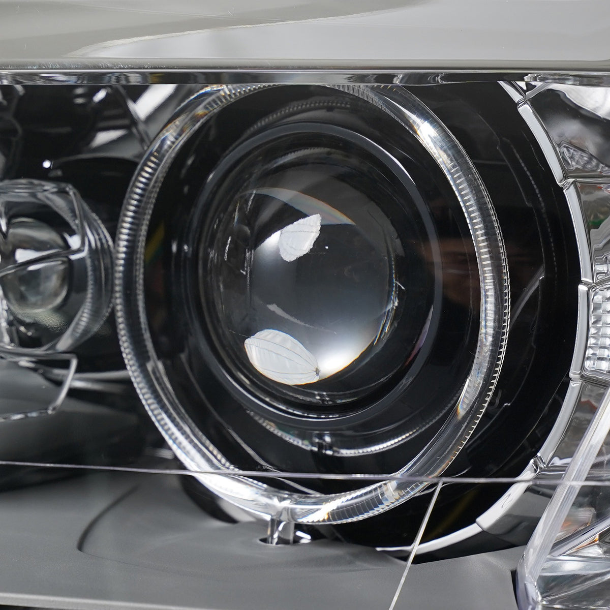 Left HID headlight lens close-up for 2011-2014 BMW X3 (F25)