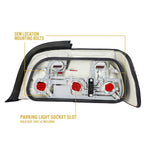 Back of the E36 coupe tail light showing OEM-location mounting bolts and bulb sockets