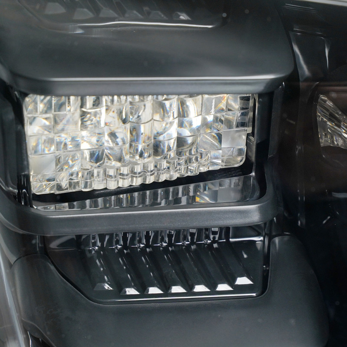 Left LED projector headlight lens close-up for 2018-2021 Ford Expedition