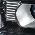 Left halogen projector headlight lens close-up for 2015-2019 GMC Sierra HD