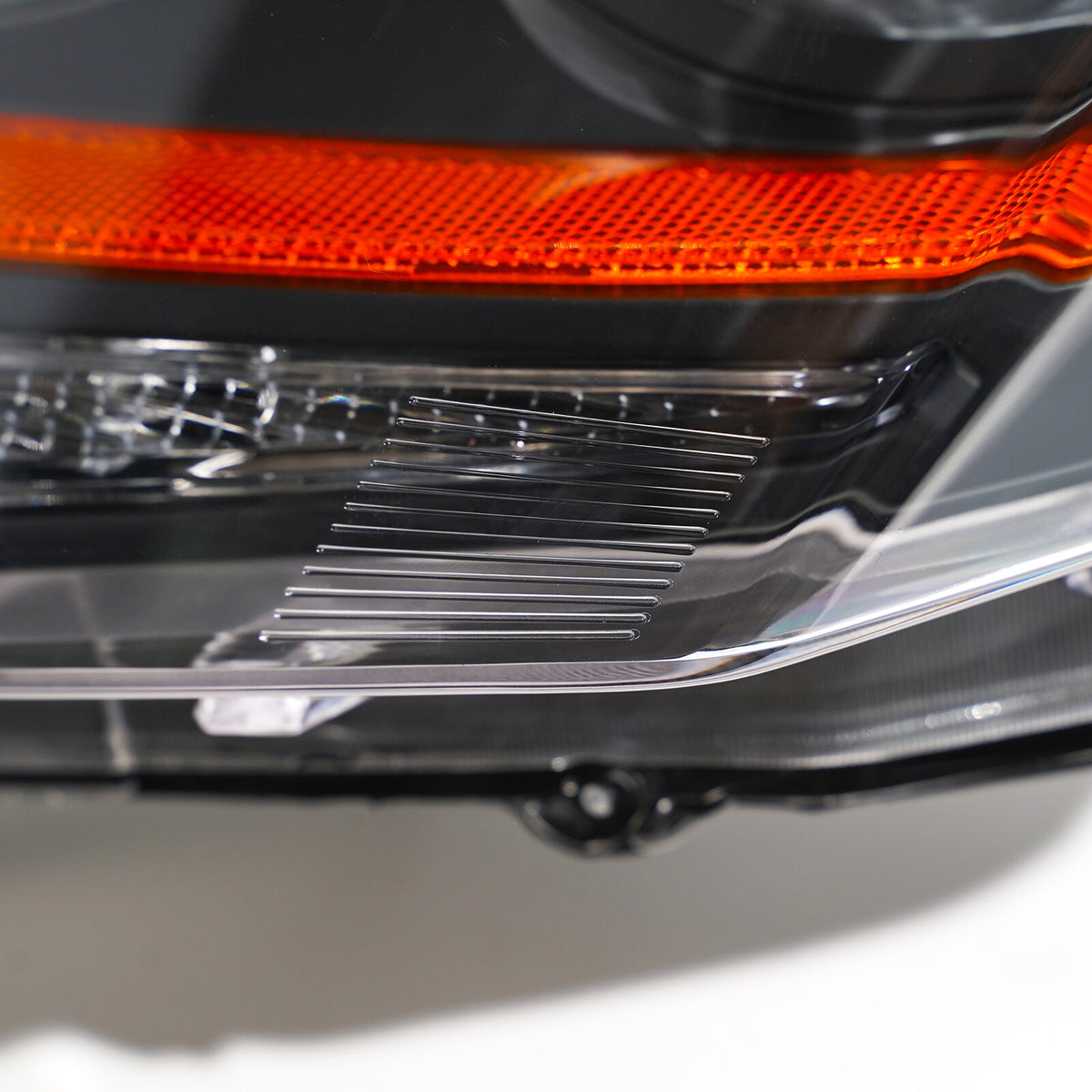 Halogen headlight mounting tab close-up for 2008-2014 Cadillac CTS