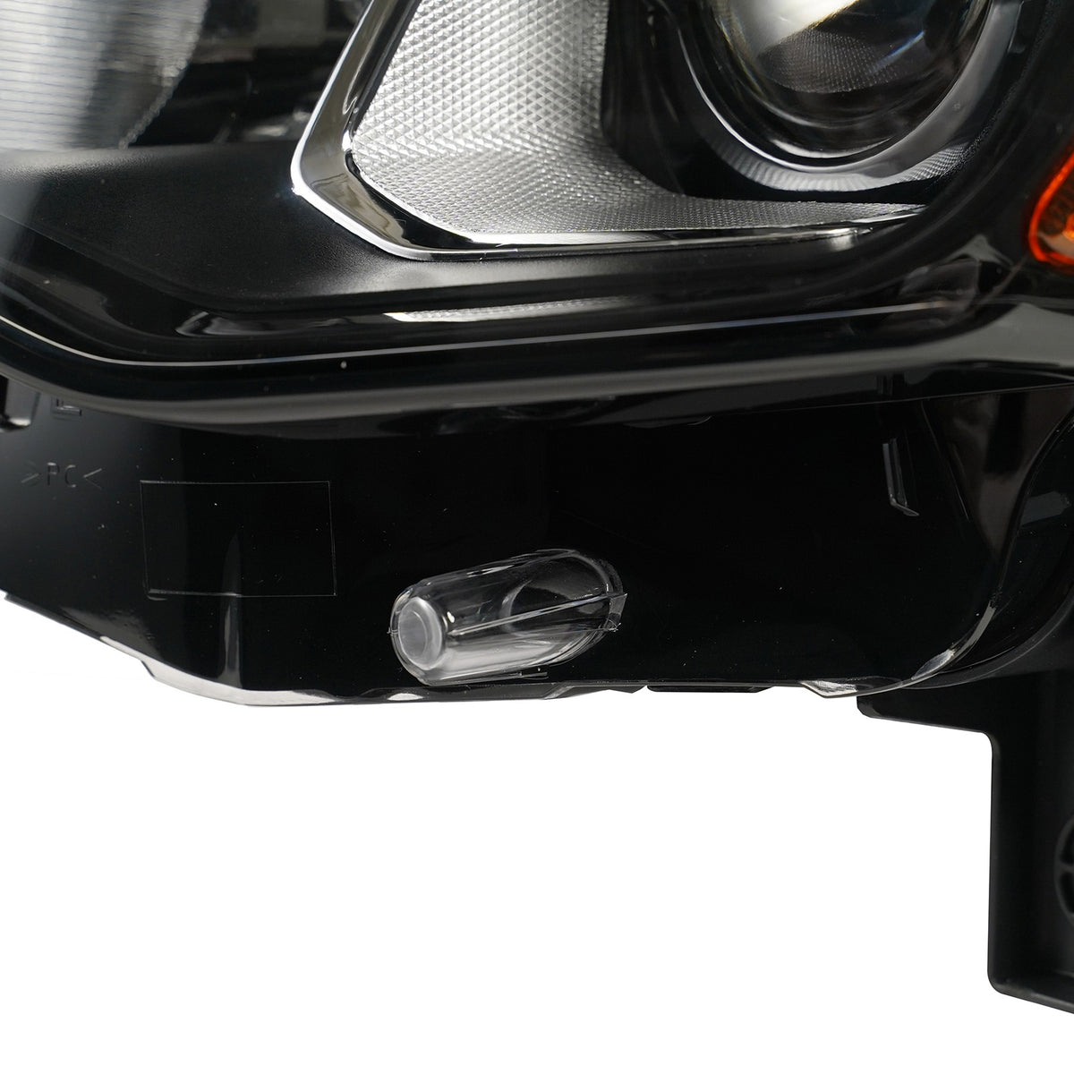 Halogen projector headlight mounting tab close-up for 2017-2021 Jeep Grand Cherokee