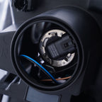 Halogen projector headlight mounting tab close-up for 2010-2012 Ford Taurus