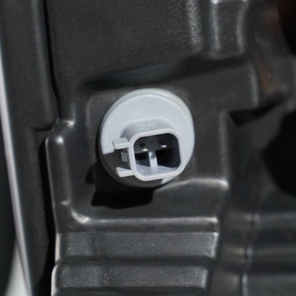 Halogen headlight mounting tab close-up for 2023-2026 Ford Super Duty