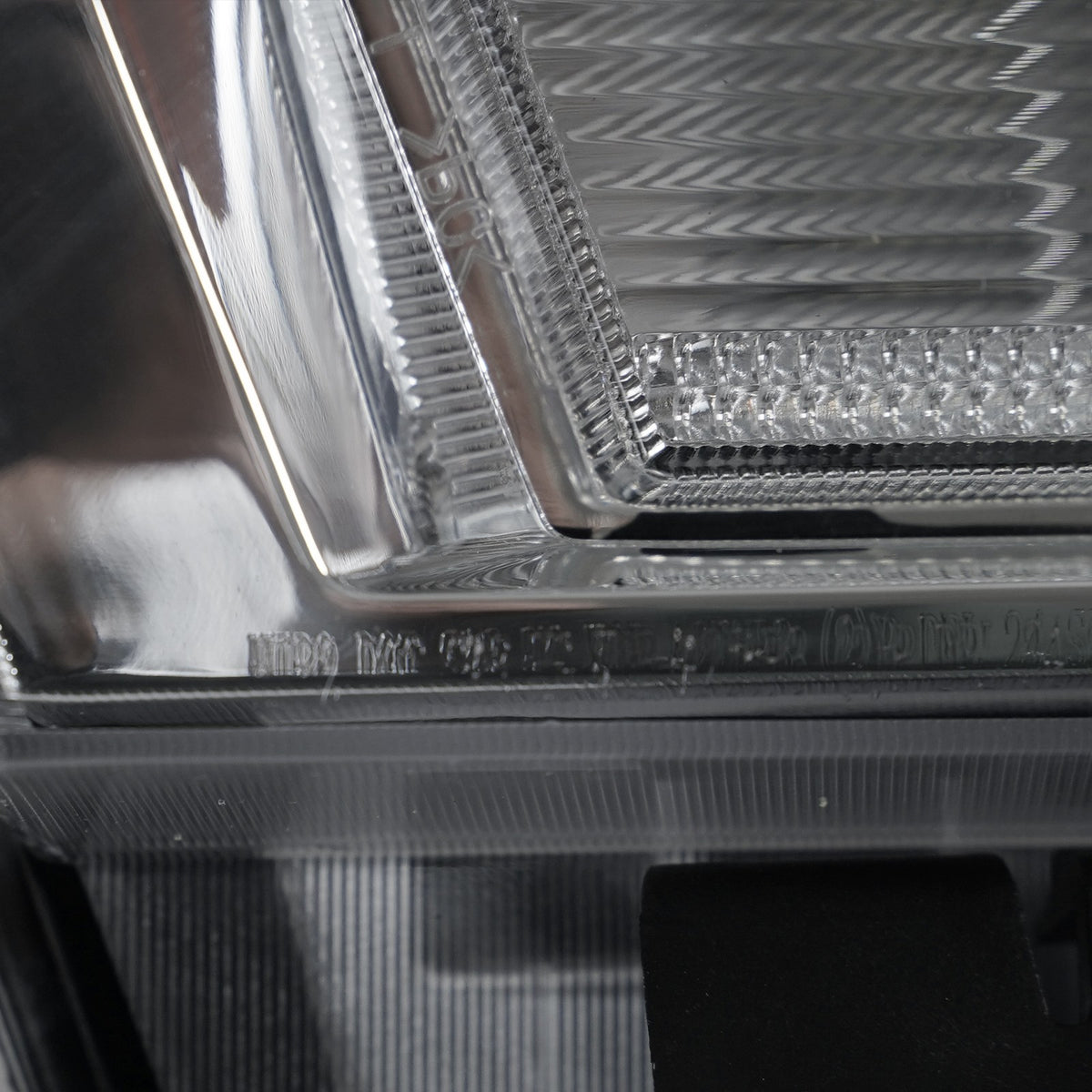 Halogen projector headlight bulb socket close-up for 2015-2019 GMC Sierra HD