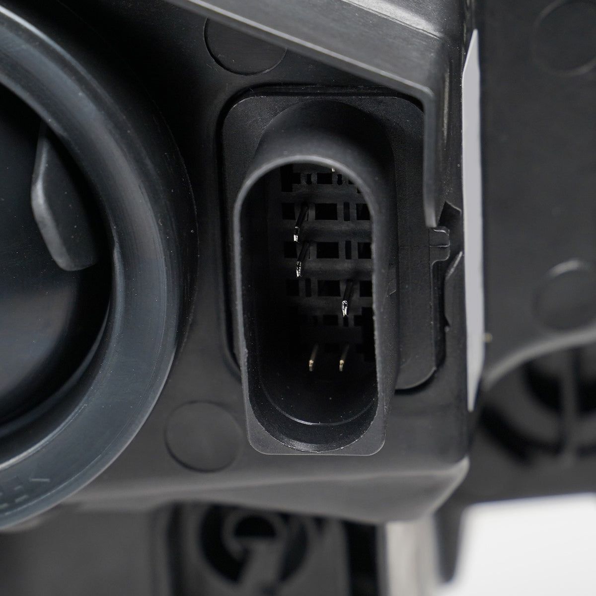 Halogen headlight mounting tab close-up for 2014-2018 Ford Transit Connect