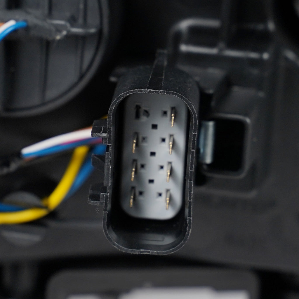 Halogen projector headlight mounting tab close-up for 2015-2019 GMC Sierra HD