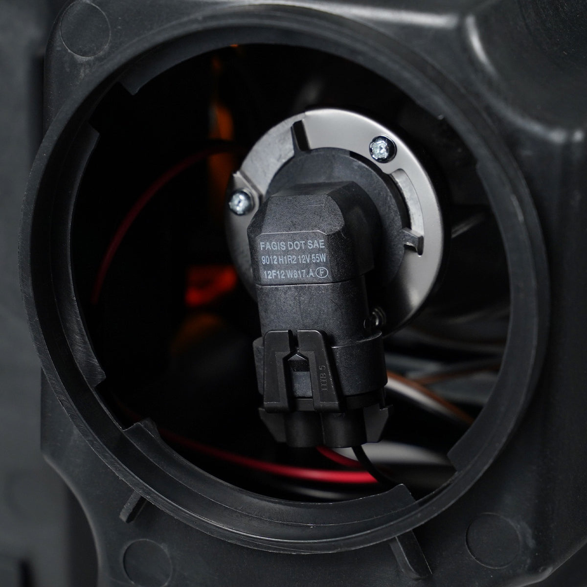 Halogen projector headlight back housing close-up for 2015-2019 GMC Sierra HD