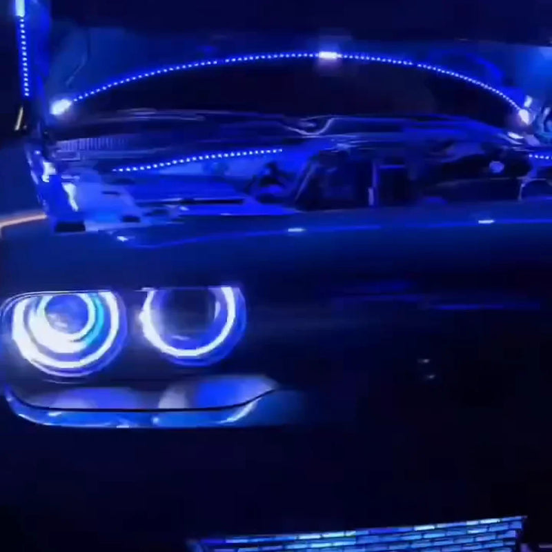 Dodge Challenger front at night with blue halo headlights and blue LED lights under the open hood
